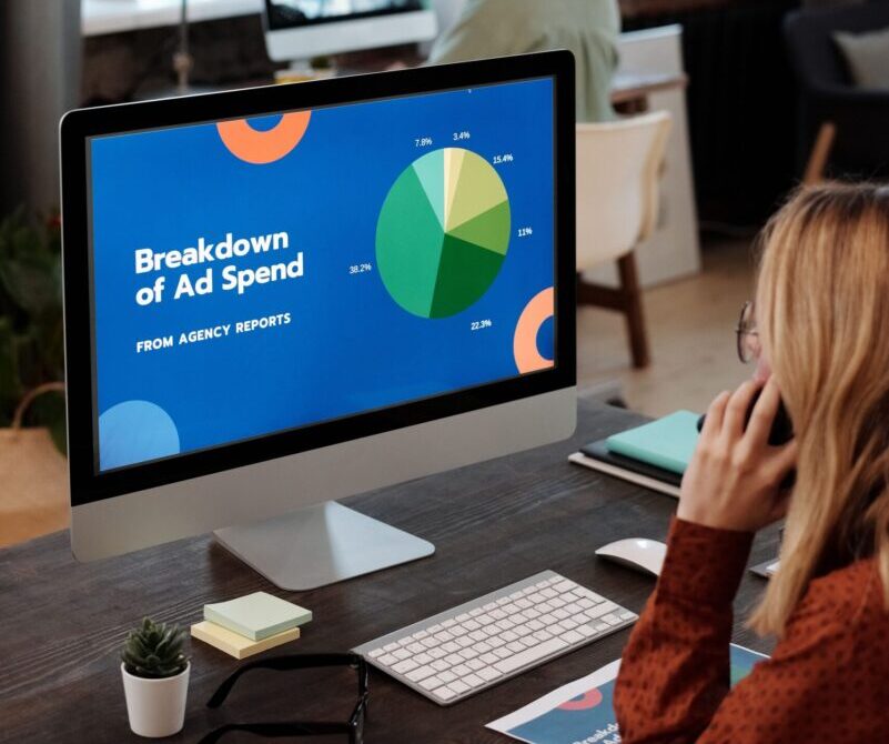 Bright office setting with computers displaying data, illustrating productivity in a workspace.